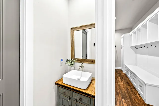 a bathroom with a sink a mirror and a shower