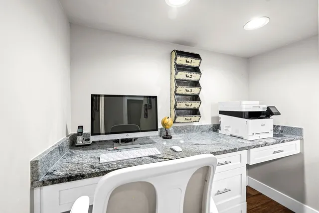 a kitchen with granite countertop a sink and a stove top oven