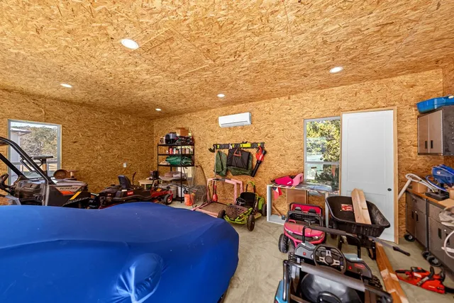 a living room with furniture gym equipment and a large window