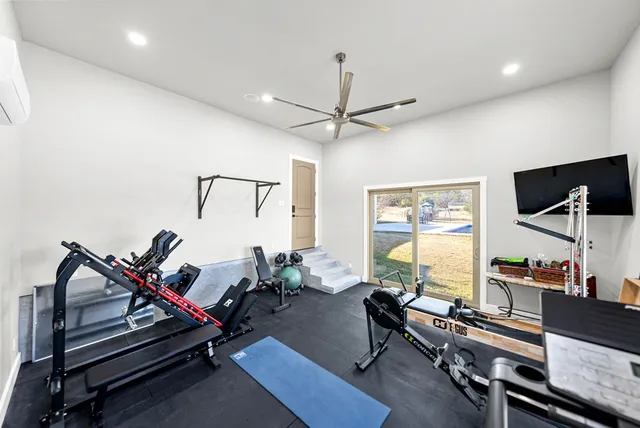 a room with lots of potted plants and wooden floor