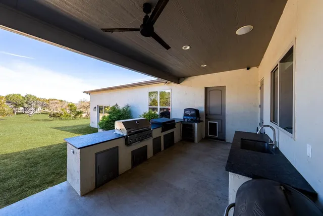an aerial view of a house with a yard