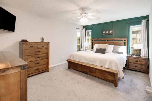 a bed room with a bed and a television