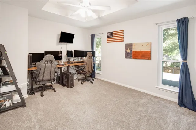 a view of a workspace with furniture and a window