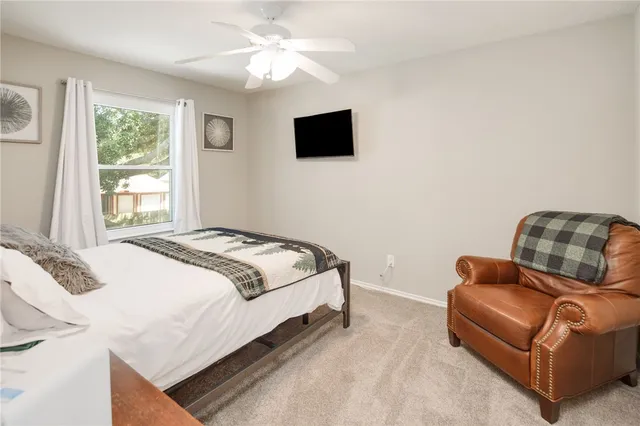 a bedroom with a bed couch and window