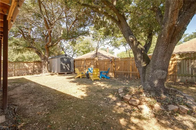 a view of a yard with a tree