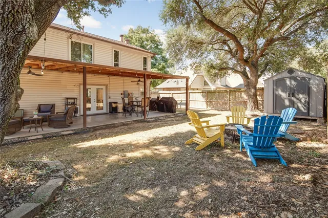 a view of a house with backyard porch and sitting area