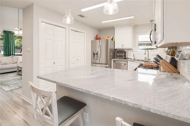 a kitchen with stainless steel appliances granite countertop a sink and counter space