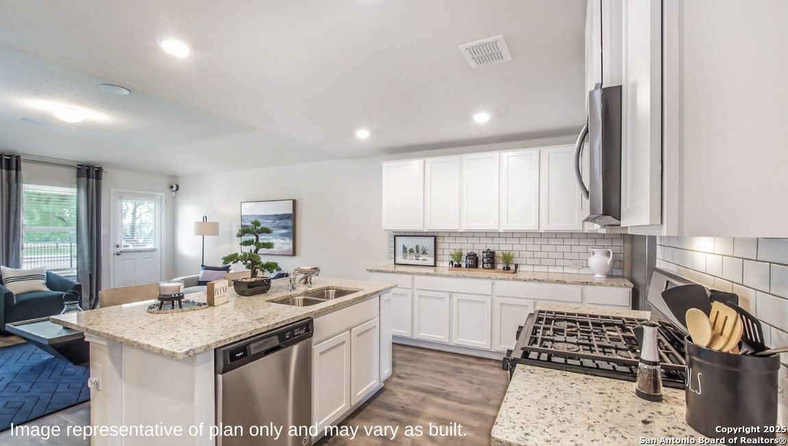 624 Fluted Shoals Cibolo, TX 78108 - Photo 6 of 38 a kitchen with a sink stove and cabinets