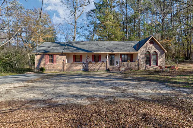 a front view of a house with a yard outdoor seating and garage