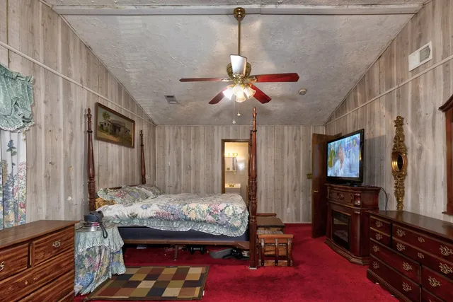 a bed room with a bed mirror and a window