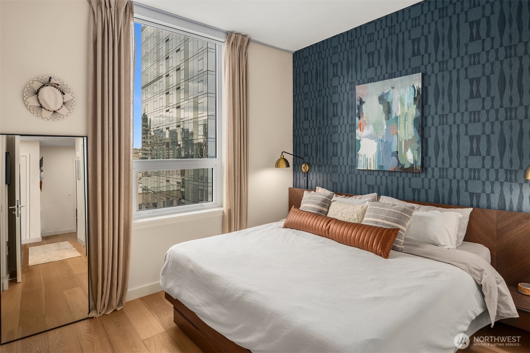 121 Stewart Street, Unit 1602 Seattle, WA 98101 - Photo 13 of 27 a bedroom with a bed and a painting on the wall