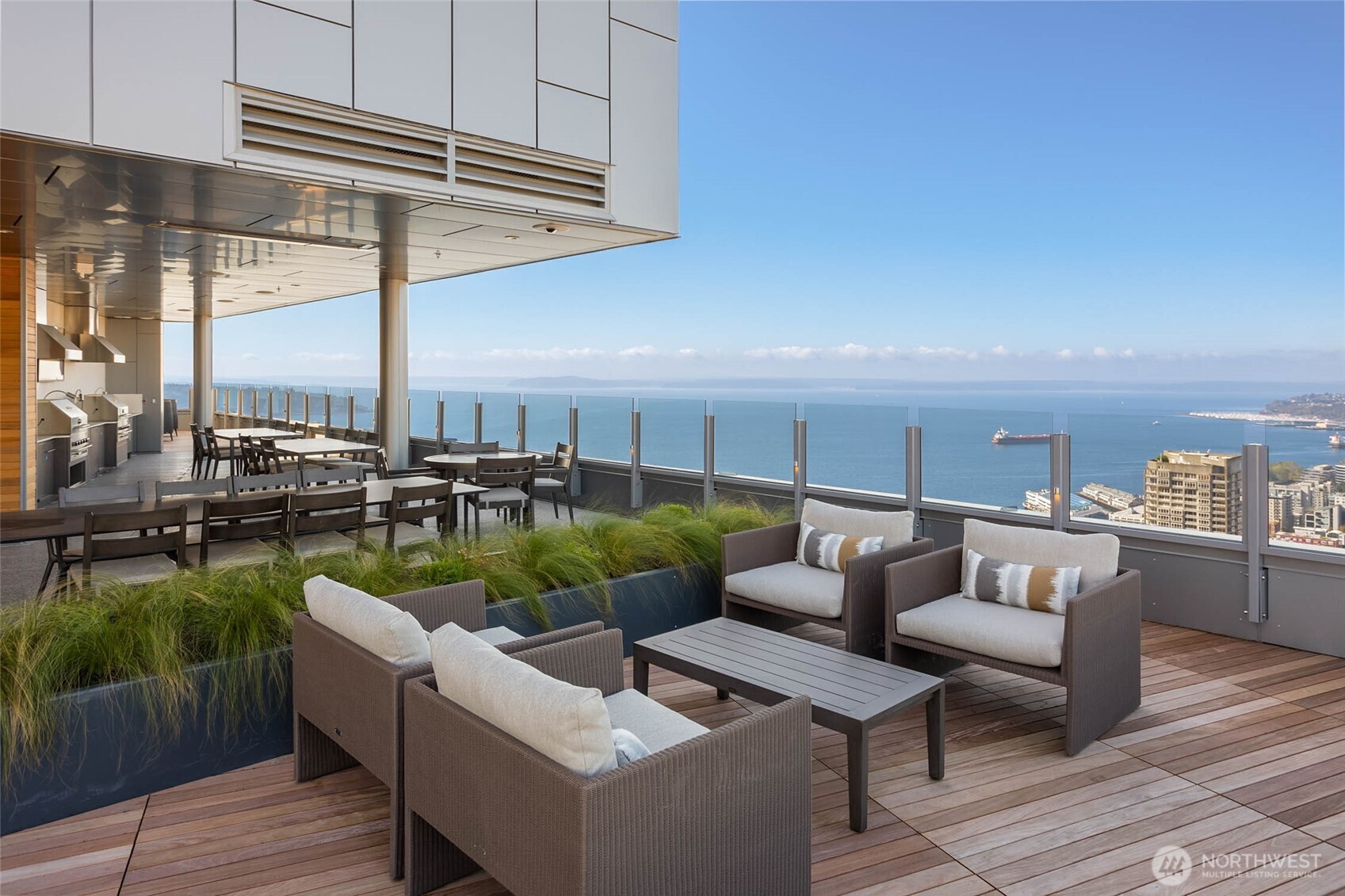 121 Stewart Street, Unit 1602 Seattle, WA 98101 - Photo 21 of 27 a roof deck with couches and potted plants with wooden floor