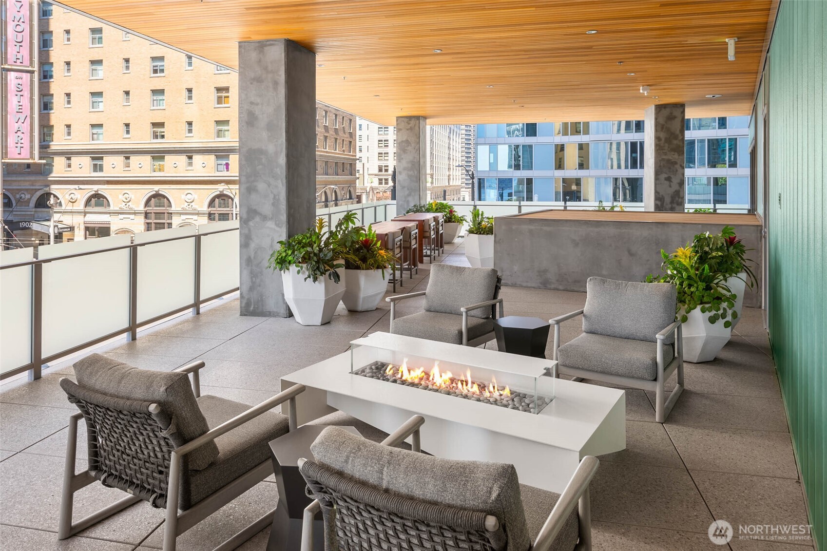121 Stewart Street, Unit 1602 Seattle, WA 98101 - Photo 22 of 27 a outdoor space with patio the couches and a potted plant on a table