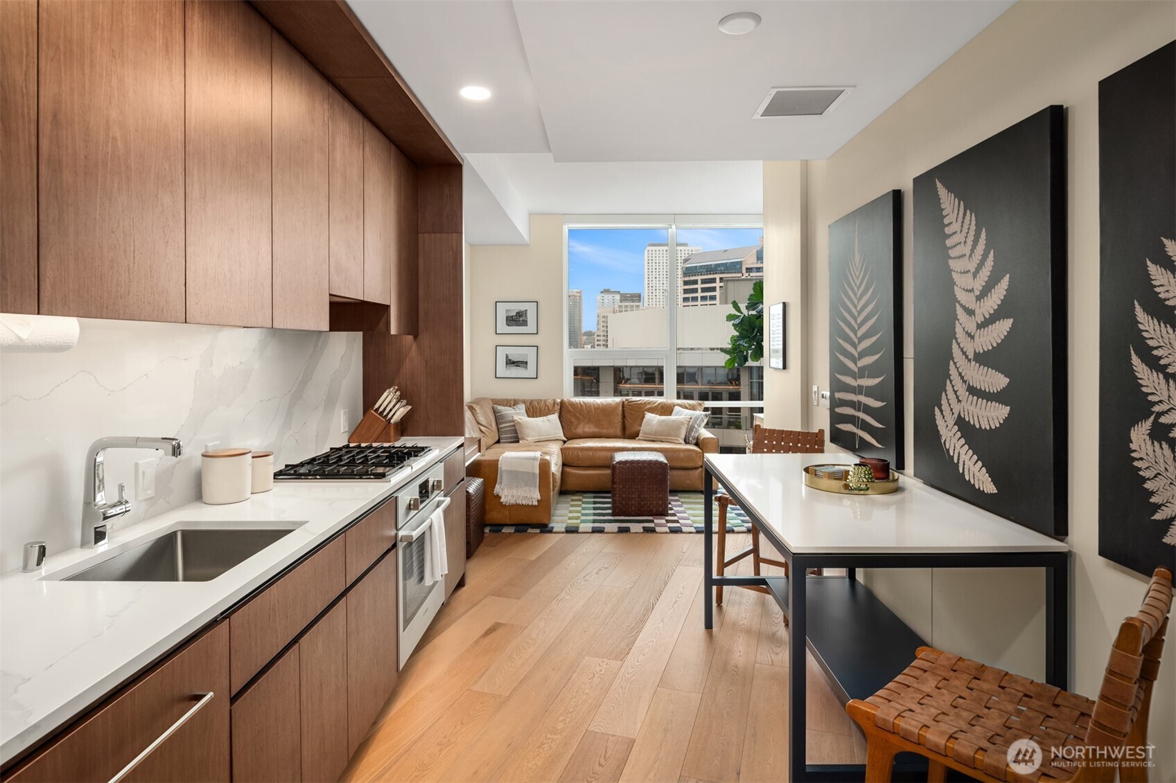 121 Stewart Street, Unit 1602 Seattle, WA 98101 - Photo 6 of 27 a kitchen with a sink stove and cabinets