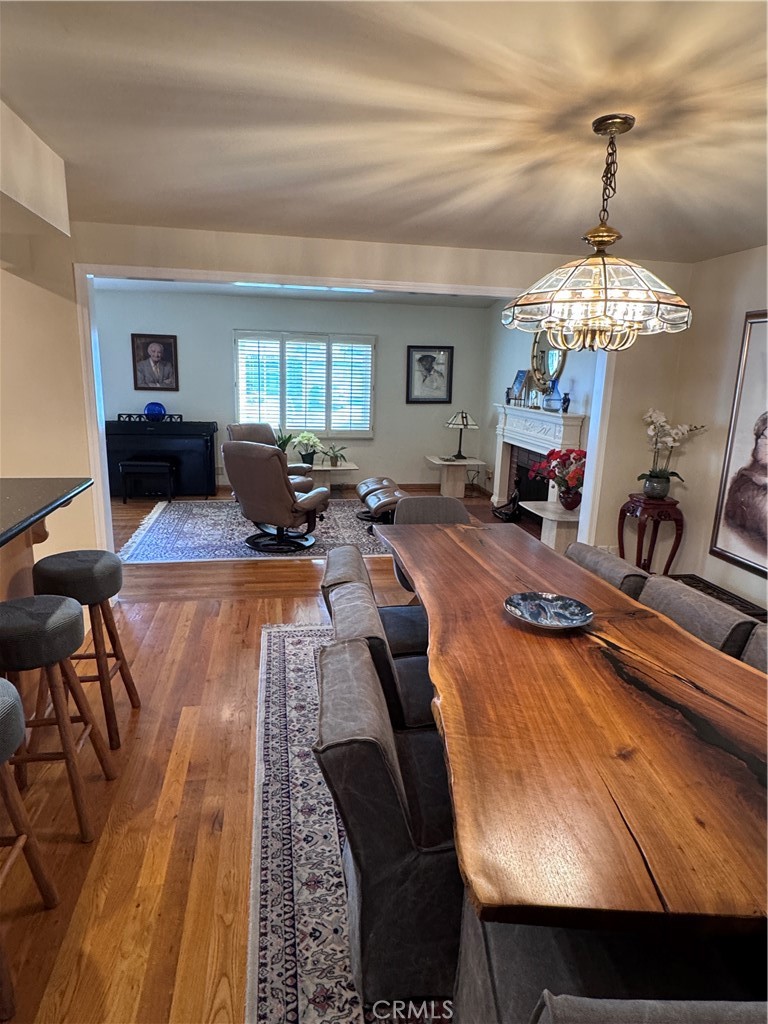 1401 Hackett Avenue Long Beach, CA 90815 - Photo 15 of 48 a living room with furniture a fireplace and a chandelier