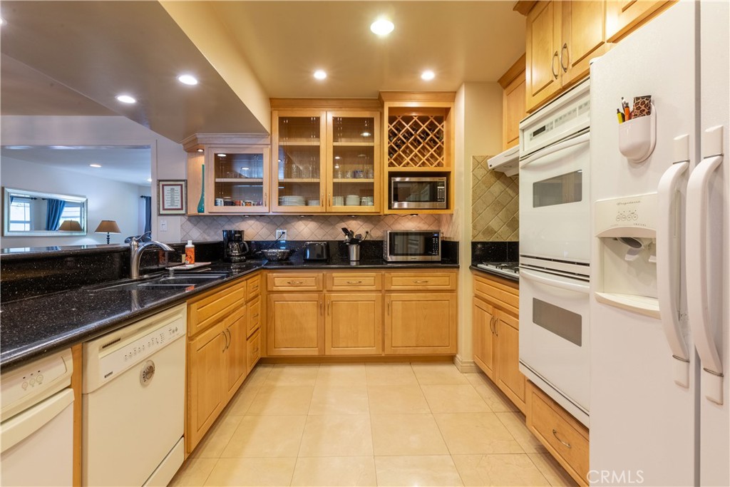 1401 Hackett Avenue Long Beach, CA 90815 - Photo 19 of 48 a kitchen with stainless steel appliances granite countertop a stove and a sink