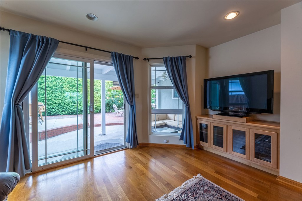 1401 Hackett Avenue Long Beach, CA 90815 - Photo 27 of 48 a living room with a flat screen tv and a floor to ceiling window