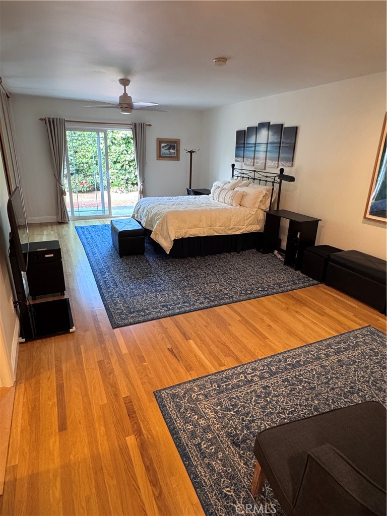 1401 Hackett Avenue Long Beach, CA 90815 - Photo 35 of 48 a bedroom with a bed and wooden floor