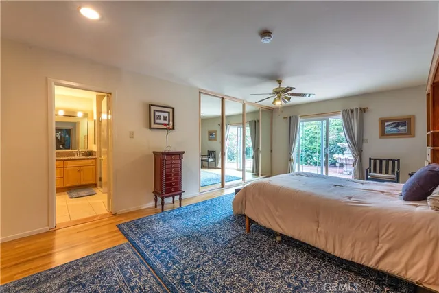 a bed sitting in a spacious bedroom next to a window