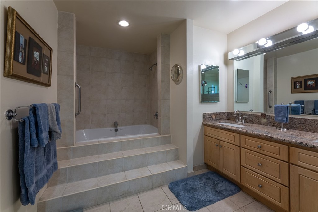 1401 Hackett Avenue Long Beach, CA 90815 - Photo 40 of 48 a bathroom with a tub a double vanity sink and a mirror
