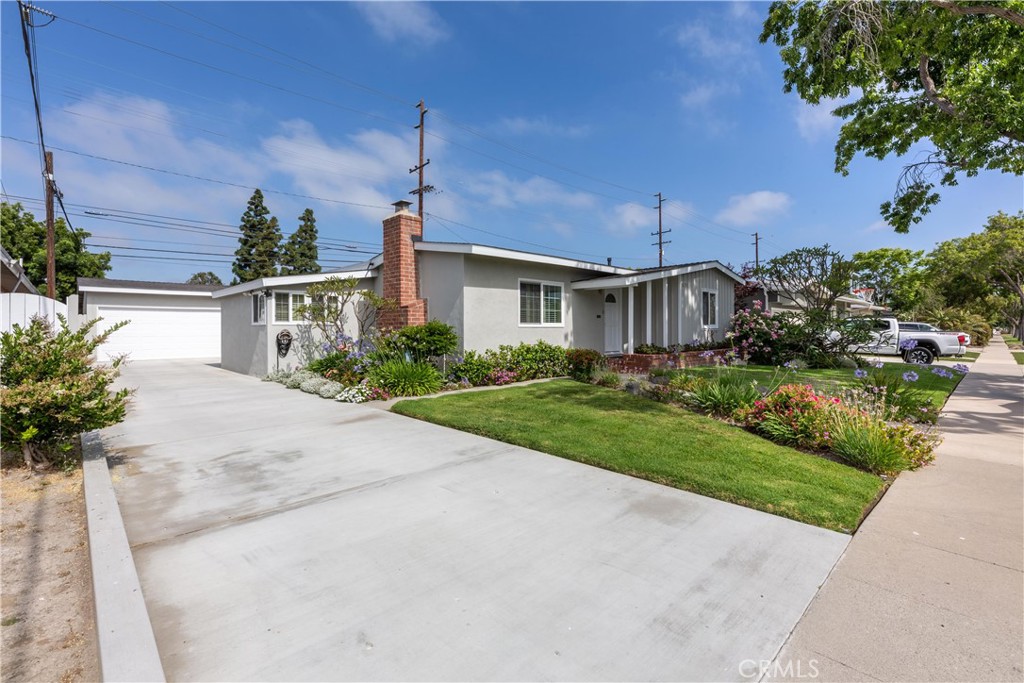 1401 Hackett Avenue Long Beach, CA 90815 - Photo 8 of 48 a front view of a house with a yard and potted plants