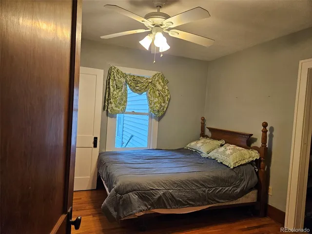 a bedroom with a bed and a refrigerator
