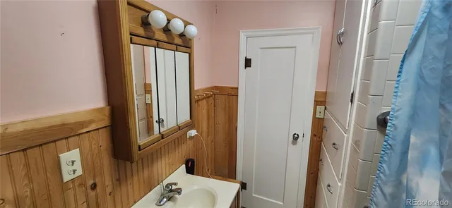 a view of a dry yard with wooden fence