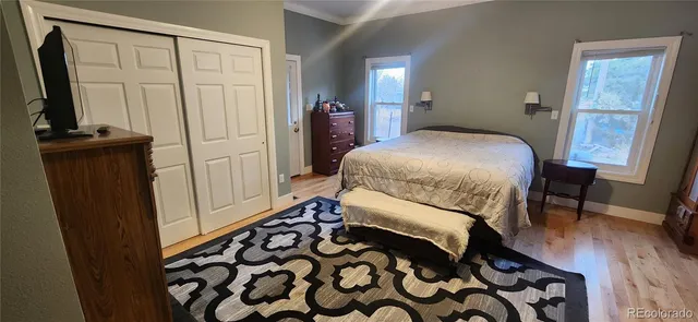 a bedroom with a bed and a mirror on dresser