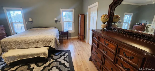 a bedroom with a bed and a mirror on dresser