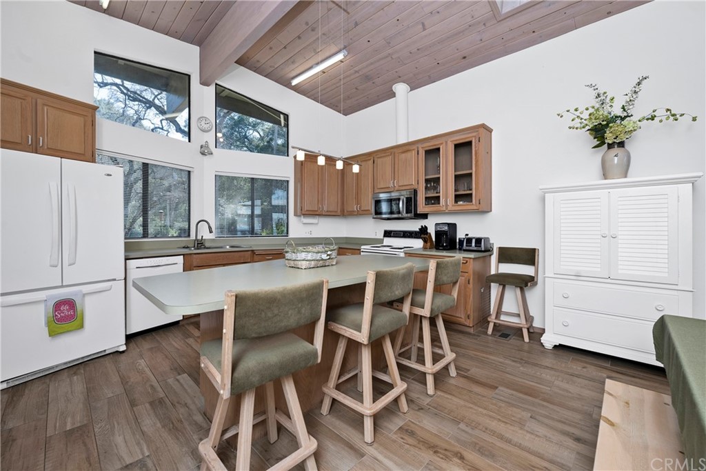 5191 Lake Boulevard Lower Lake, CA 95457 - Photo 11 of 44 a kitchen with stainless steel appliances white cabinets and wooden floor