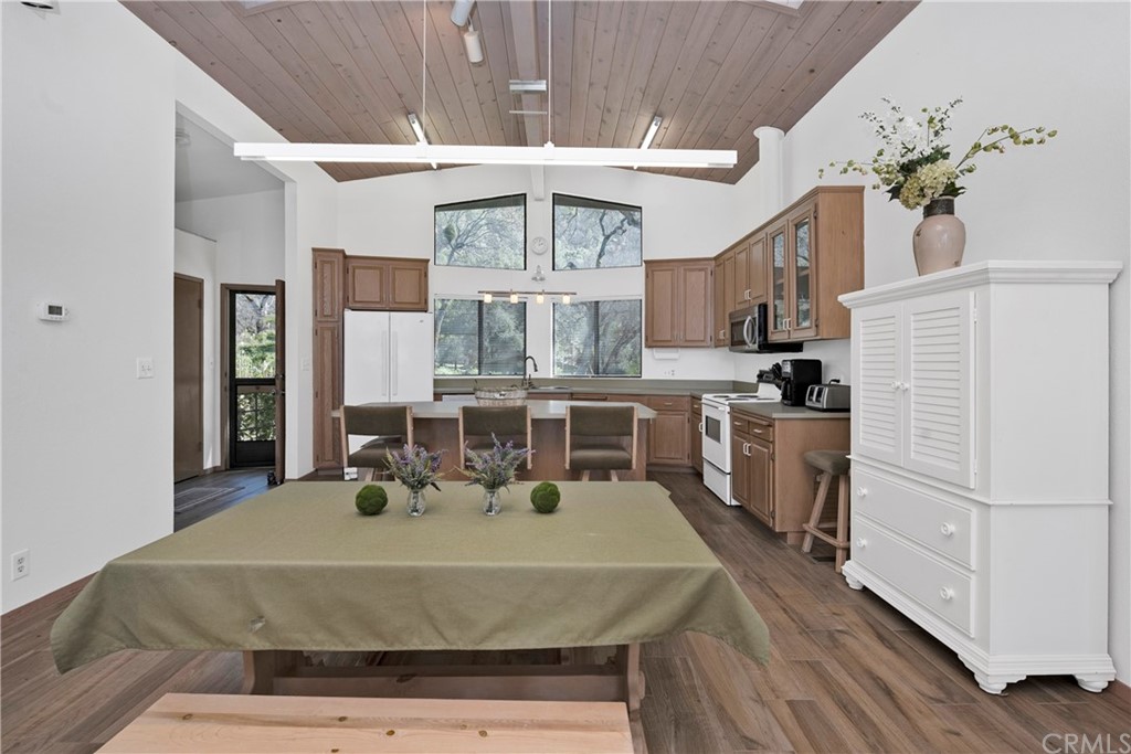 5191 Lake Boulevard Lower Lake, CA 95457 - Photo 8 of 44 a kitchen with stainless steel appliances granite countertop a stove a refrigerator a sink dishwasher and white cabinets with wooden floor