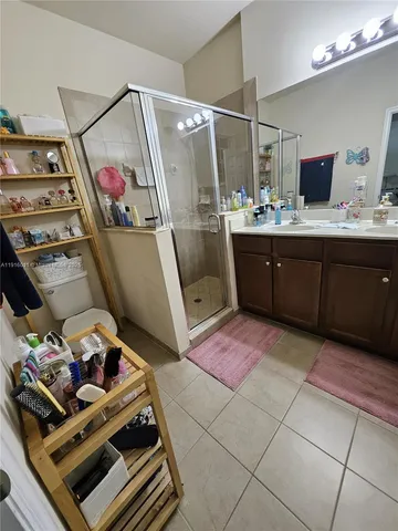 a bathroom with a sink mirror and vanity