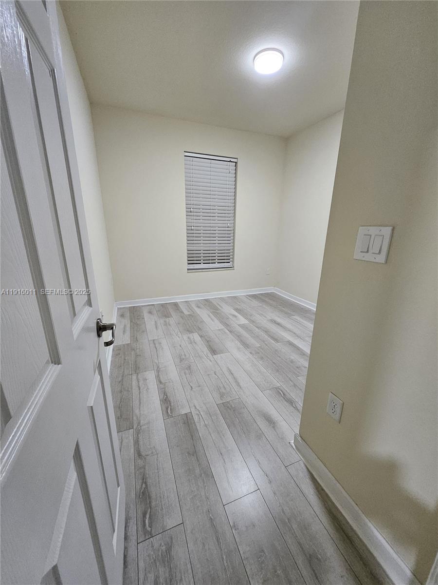9572 Southwest 169th Place Miami, FL 33196 - Photo 9 of 14 a view of a room with wooden floor and staircase