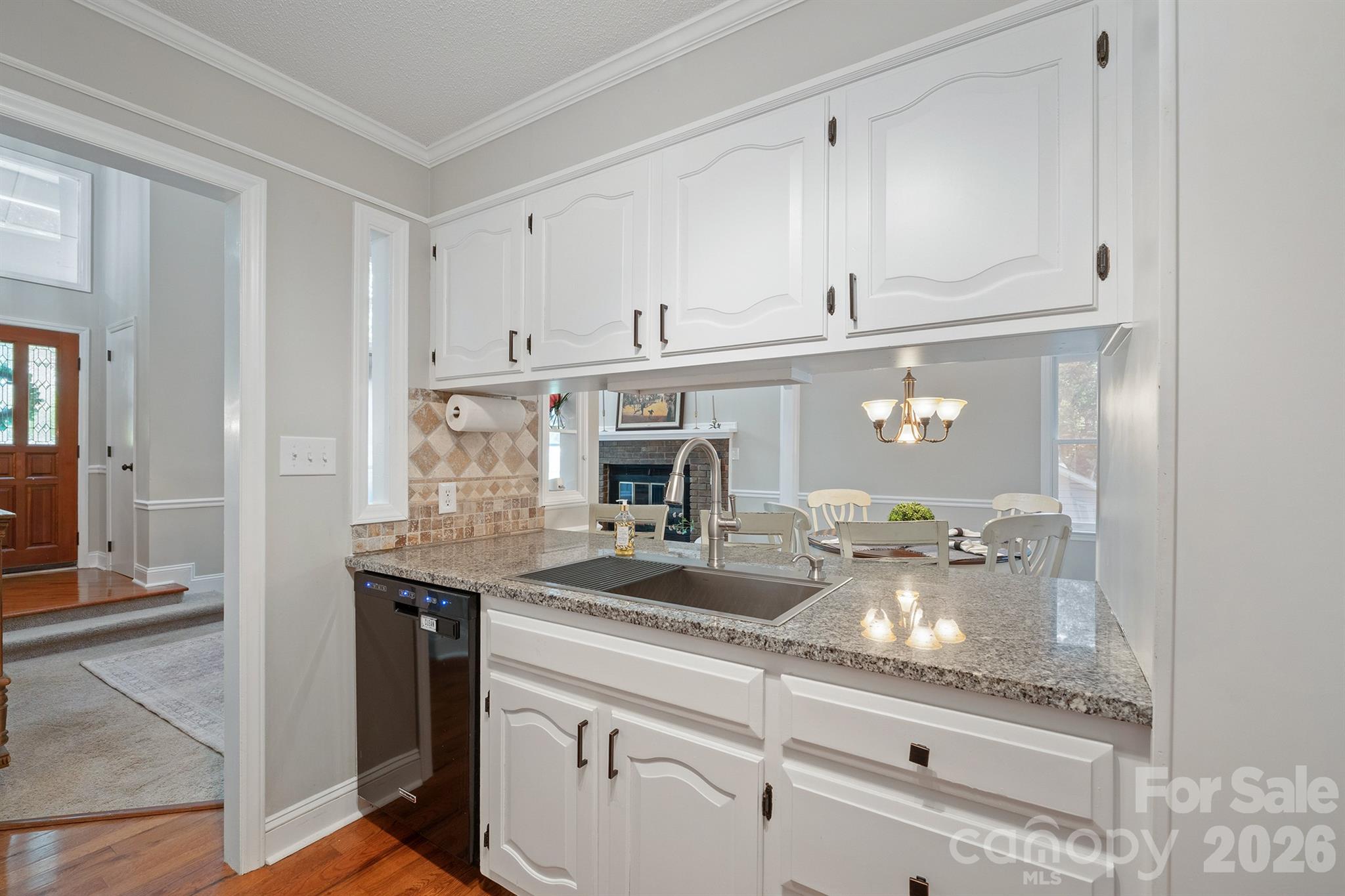 19017 Kailua Circle Tega Cay, SC 29708 - Photo 13 of 46 a kitchen with kitchen island granite countertop white cabinets and refrigerator
