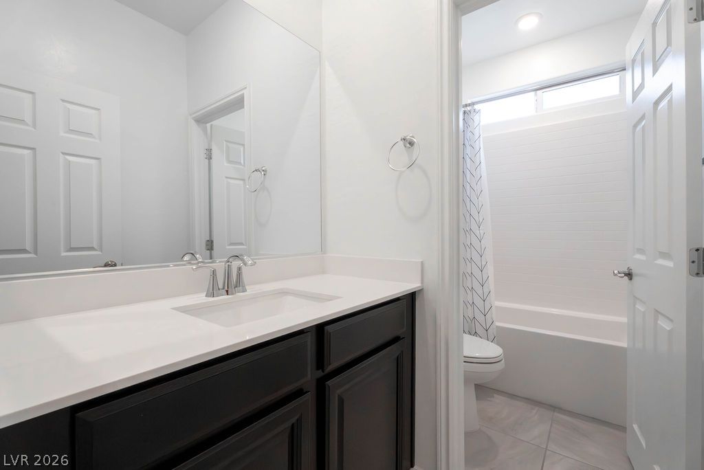 7126 Calvert Cliffs Street North Las Vegas, NV 89084 - Photo 27 of 44 A well-appointed bath features a sleek vanity and a shower-tub combination, providing comfort and function.