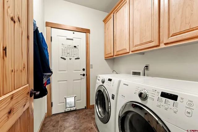 a view of washer and dryer with kitchen in the background