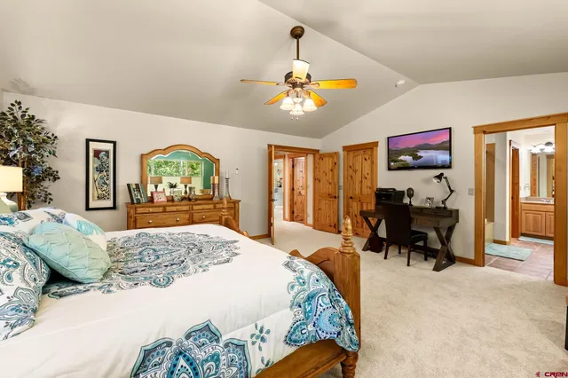 a bedroom with a bed a chandelier and closet
