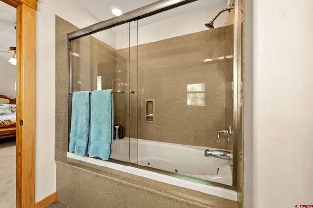 a bathroom with a bathtub and a shower