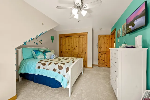 a bedroom with a bed dresser and a window