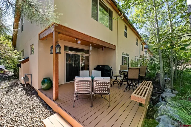 a view of a patio with a table and chairs and wooden floor