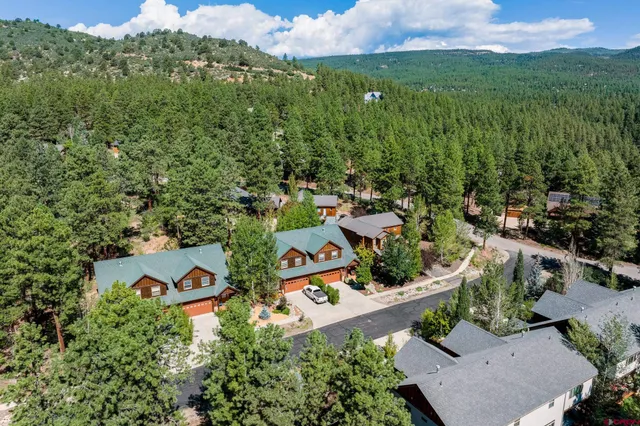 an aerial view of a house with a yard