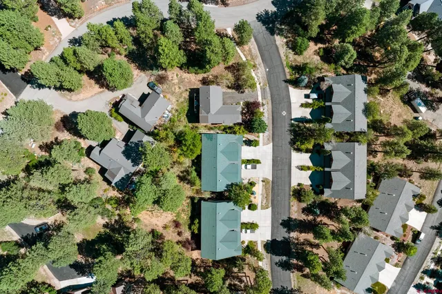an aerial view of residential houses with outdoor space