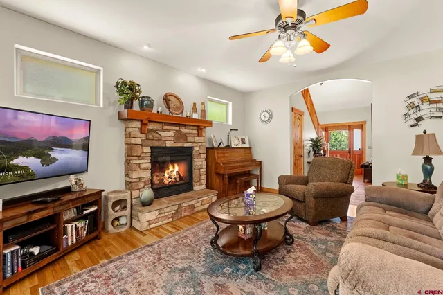 a living room with furniture a flat screen tv and a fireplace