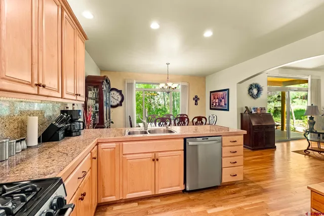 a kitchen with stainless steel appliances granite countertop a sink and cabinets