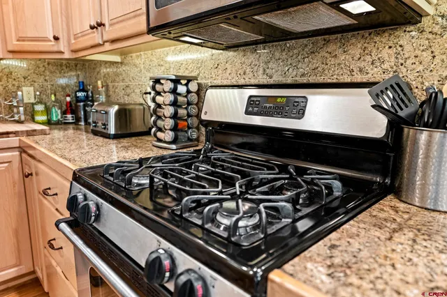 a stove top oven sitting inside of a kitchen