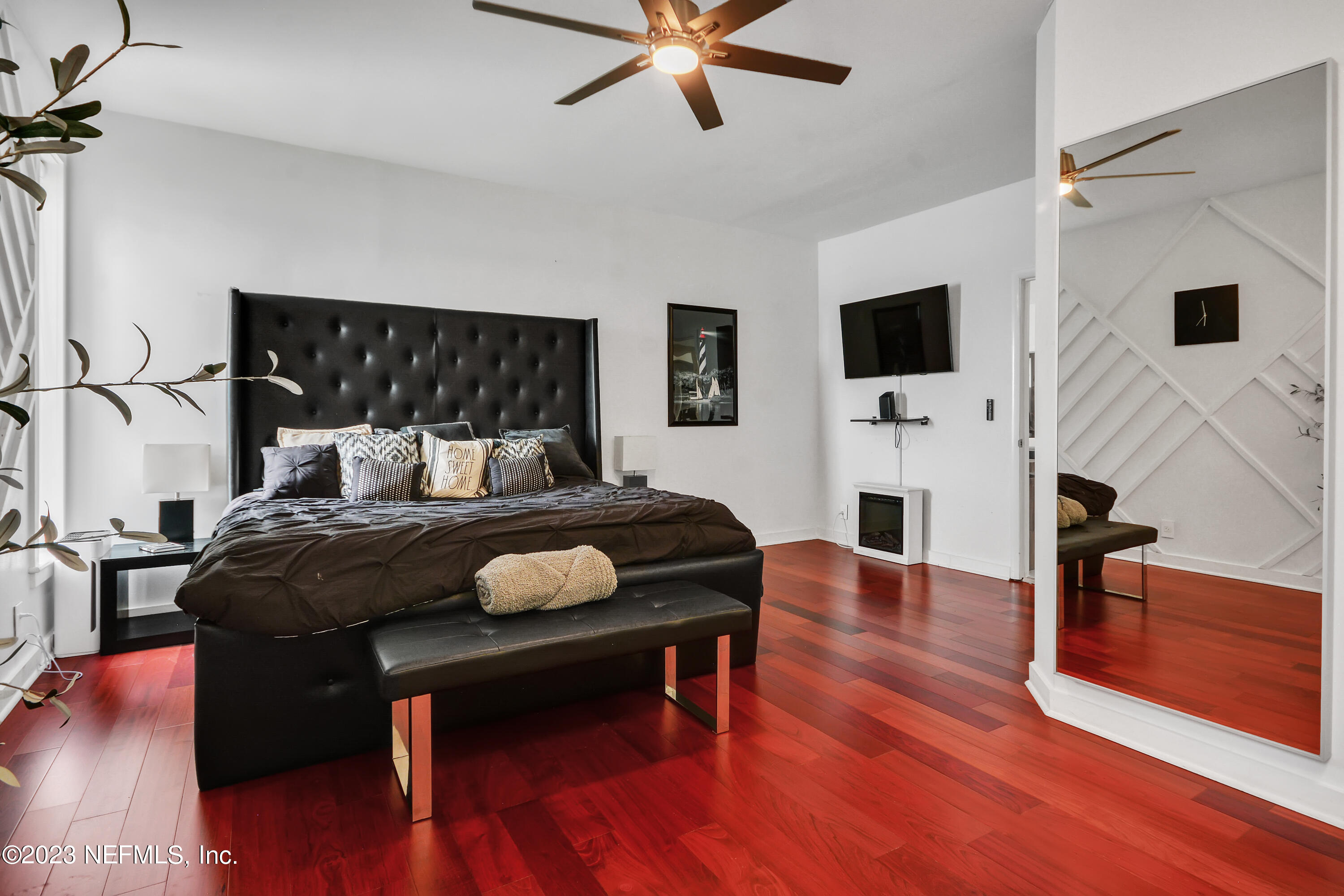 18 North St Augustine Boulevard, Unit 11 St. Augustine, FL 32080 - Photo 20 of 37 a bedroom with a bed and wooden floor