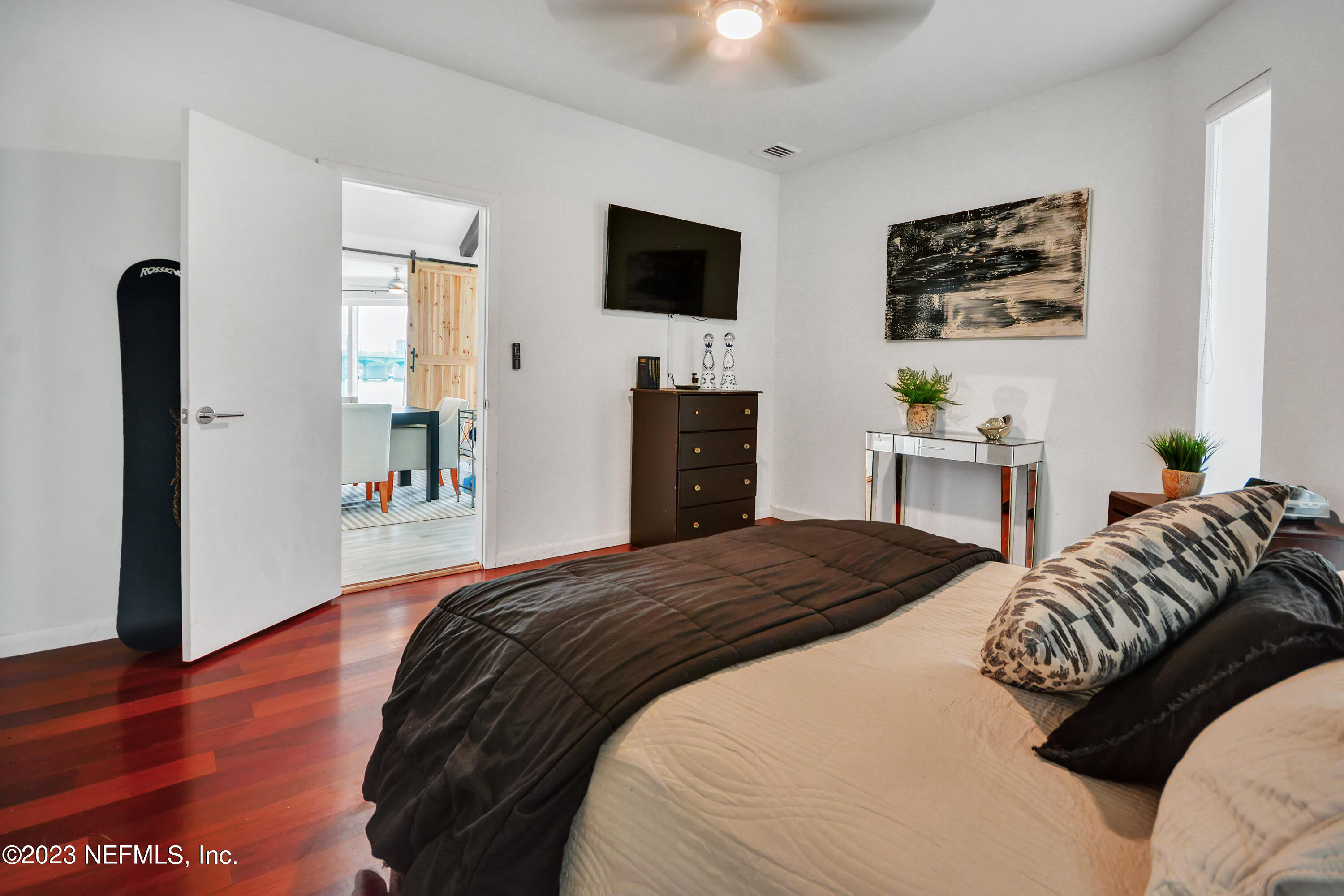 18 North St Augustine Boulevard, Unit 11 St. Augustine, FL 32080 - Photo 25 of 37 a bedroom with a bed and a flat tv screen on dresser