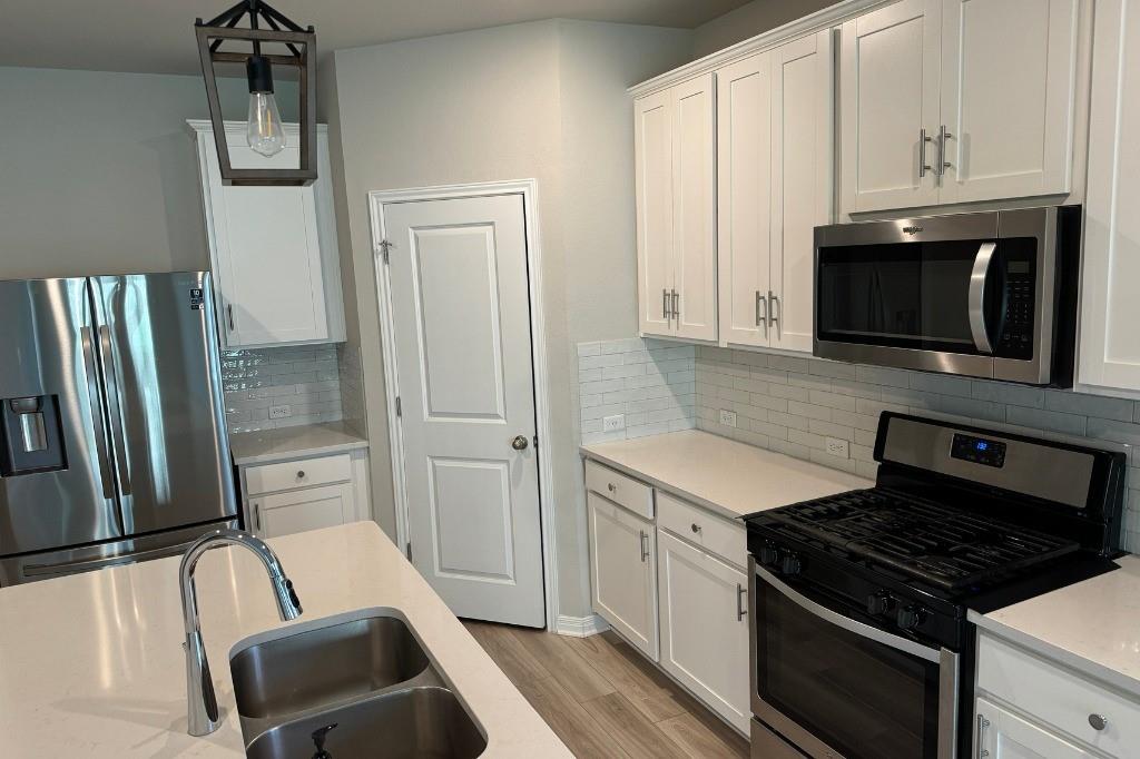 12604 Dairywork Road Buda, TX 78610 - Photo 4 of 20 Culinary delights await in this modern kitchen with gleaming stainless steel appliances.