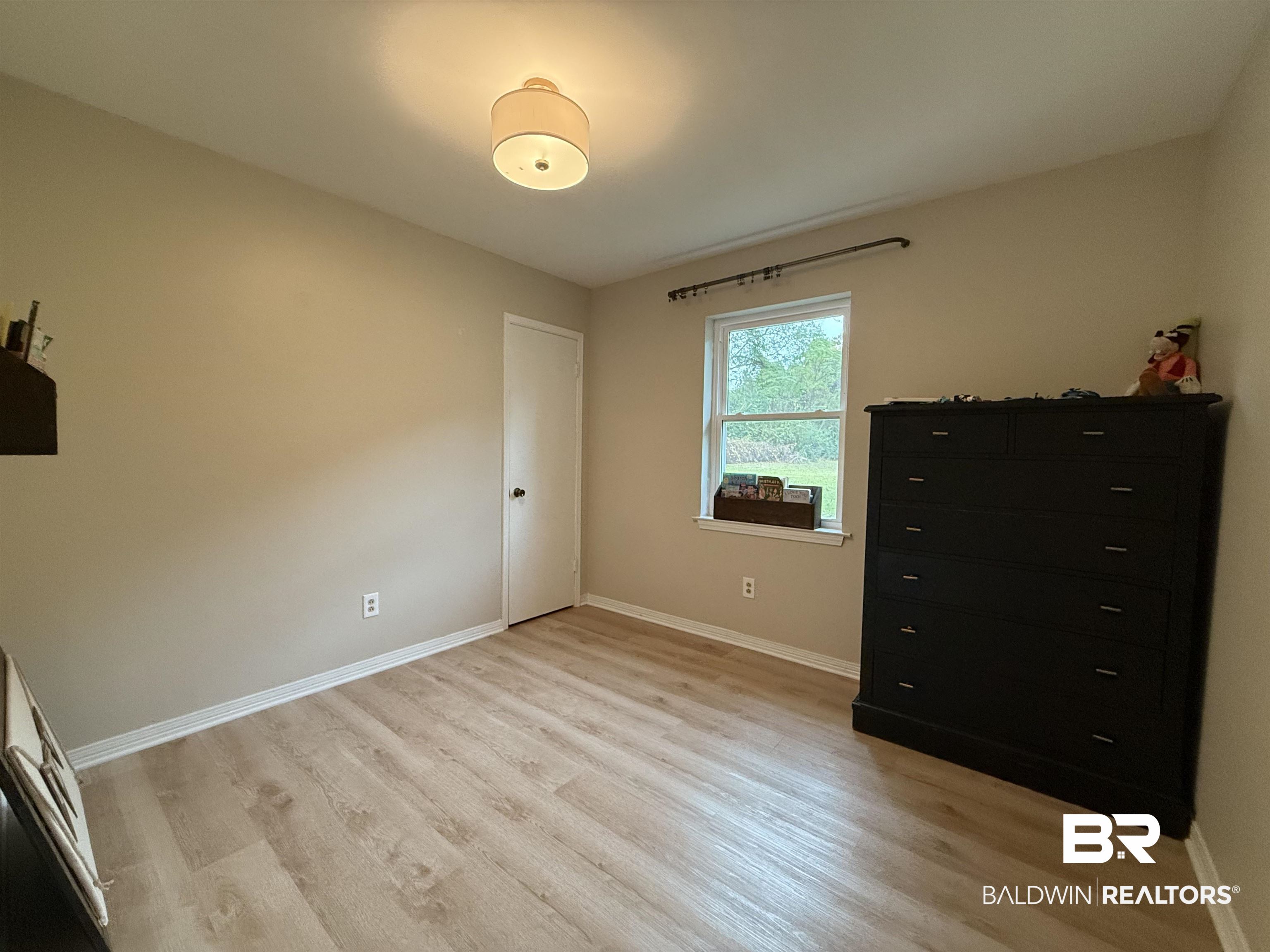 90 Florida Street Monroeville, AL 36460 - Photo 25 of 31 Unfurnished bedroom featuring light hardwood / wood-ook vinyl plank flooring