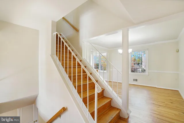 a view of a room with wooden floor and staircase